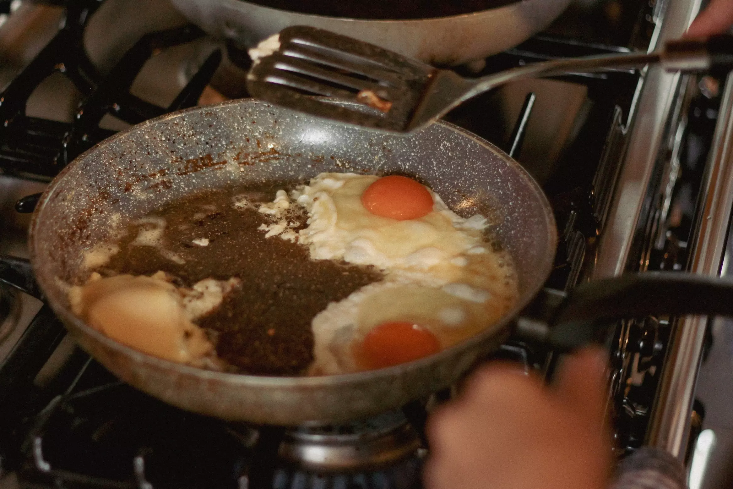 Two eggs frying in pan