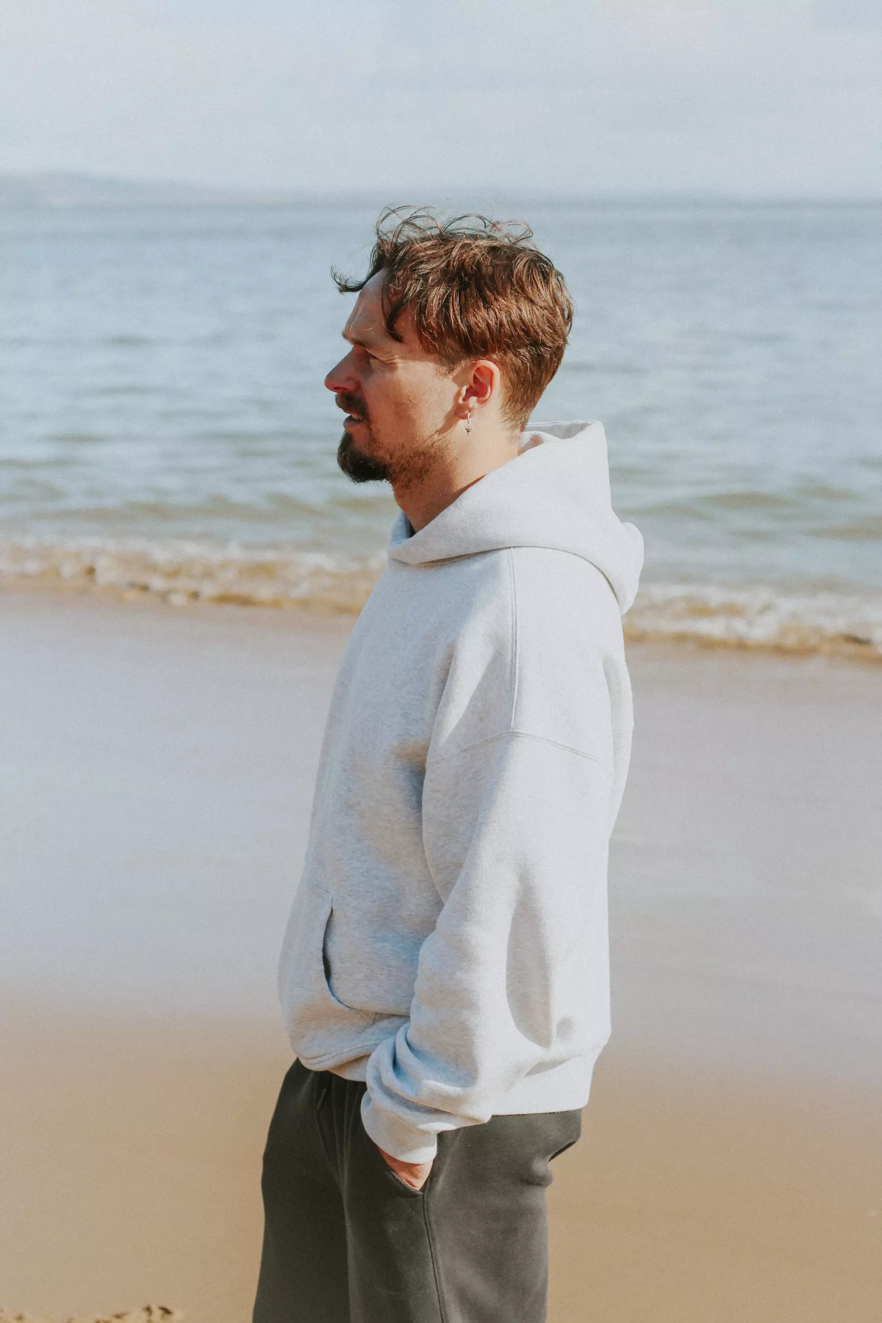 Male stood by seafront on beach