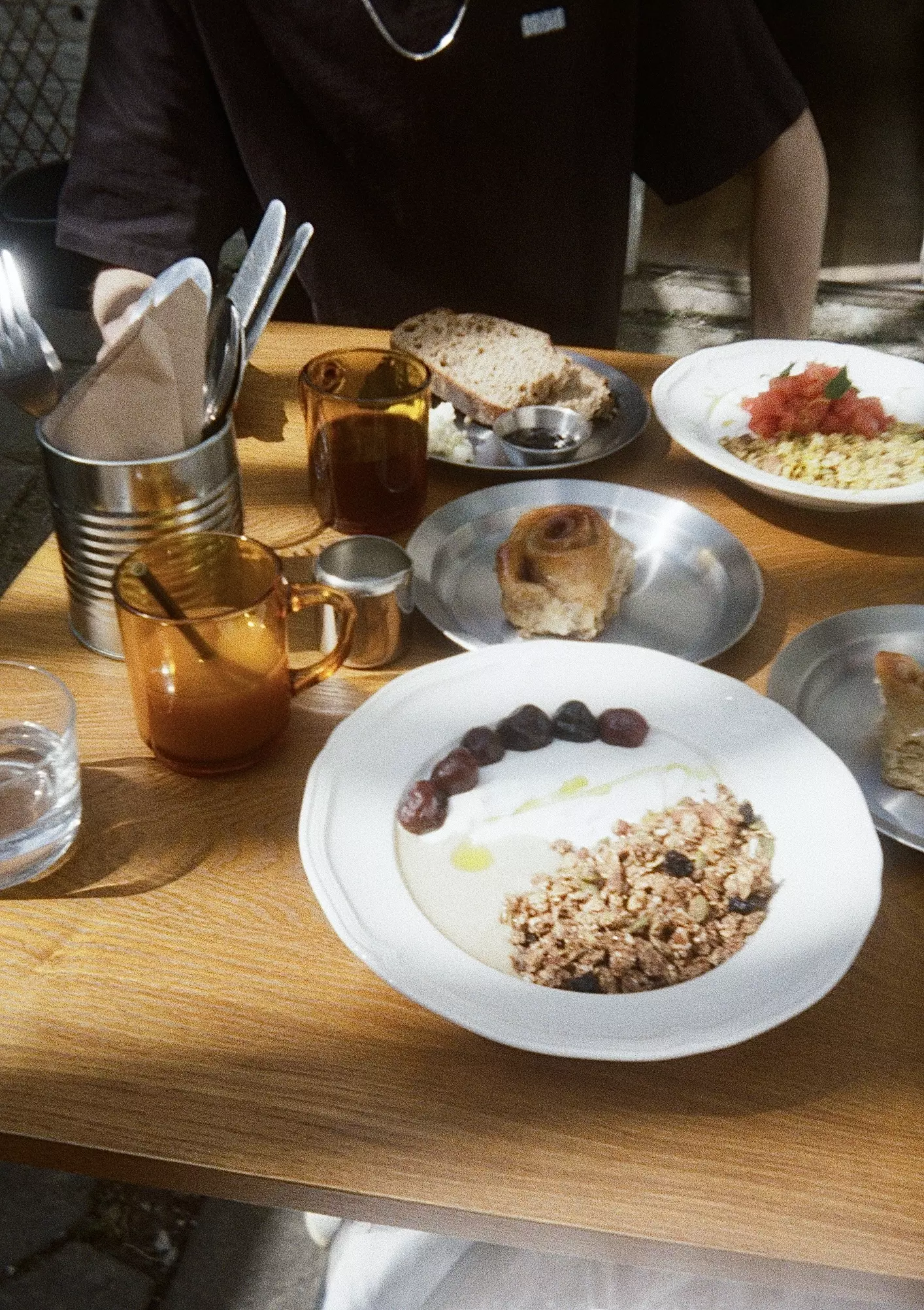 Selection of breakfast plates and coffee on a table outside
