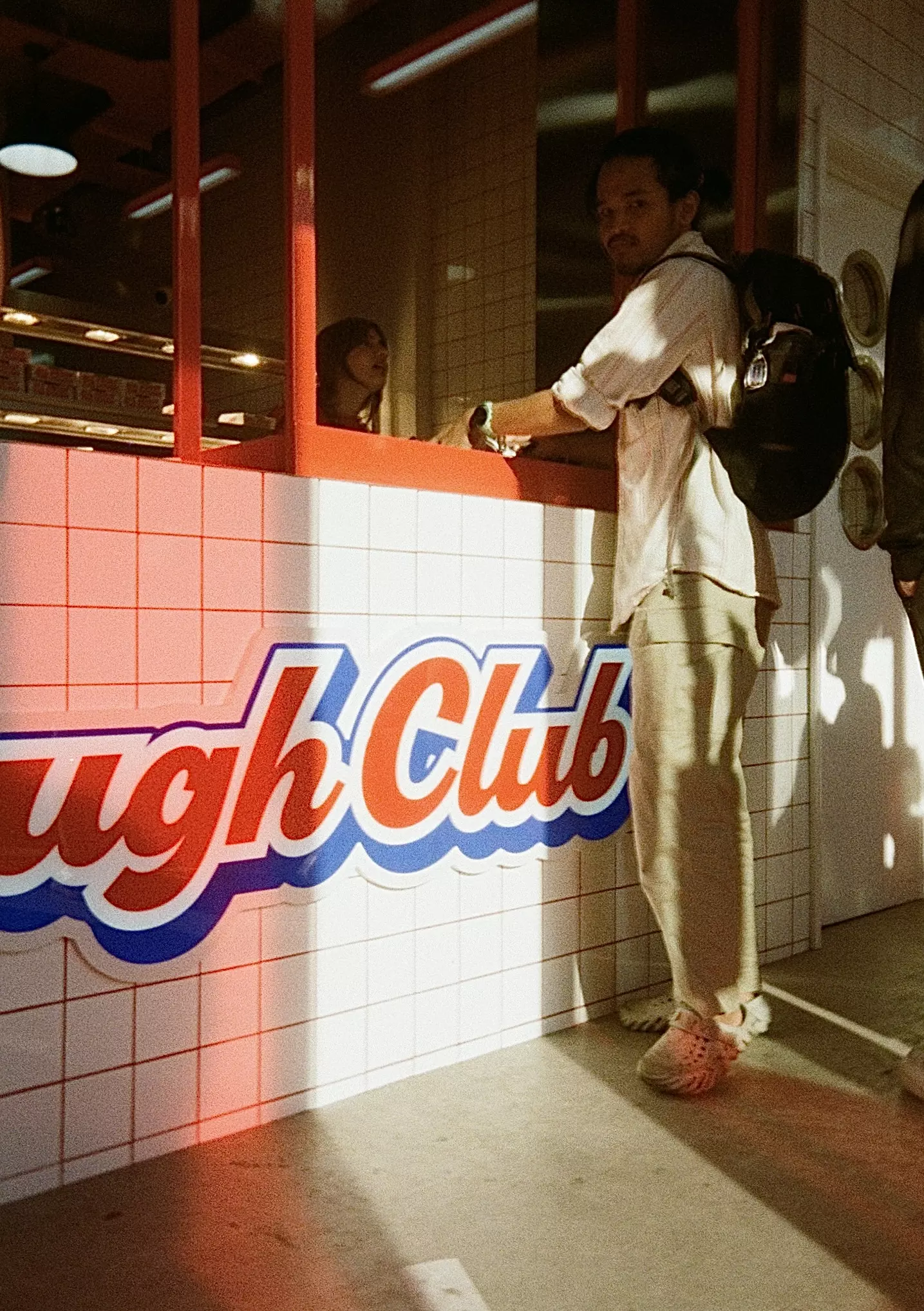 Dough Club Pizza packaging set against a white tiled wall