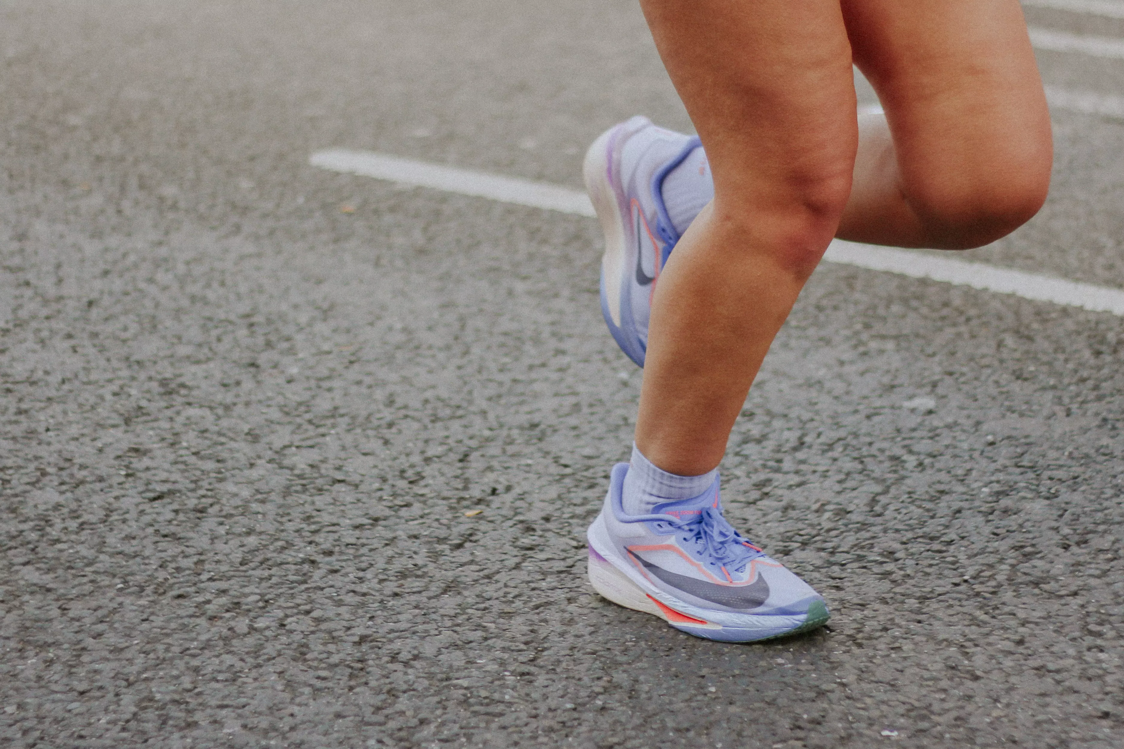 Leg shot of feet running in purple trainers