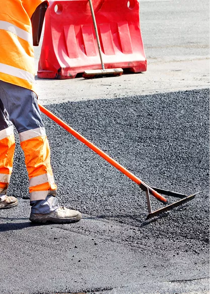 Engineer holding rake on concrete.jpg