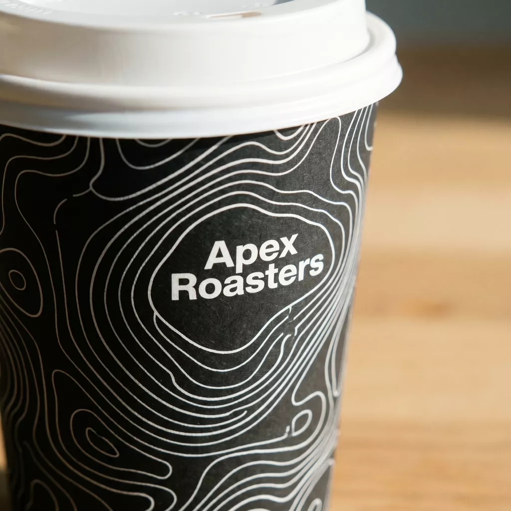 Custom printed black coffee cup with detailed white topographic line design