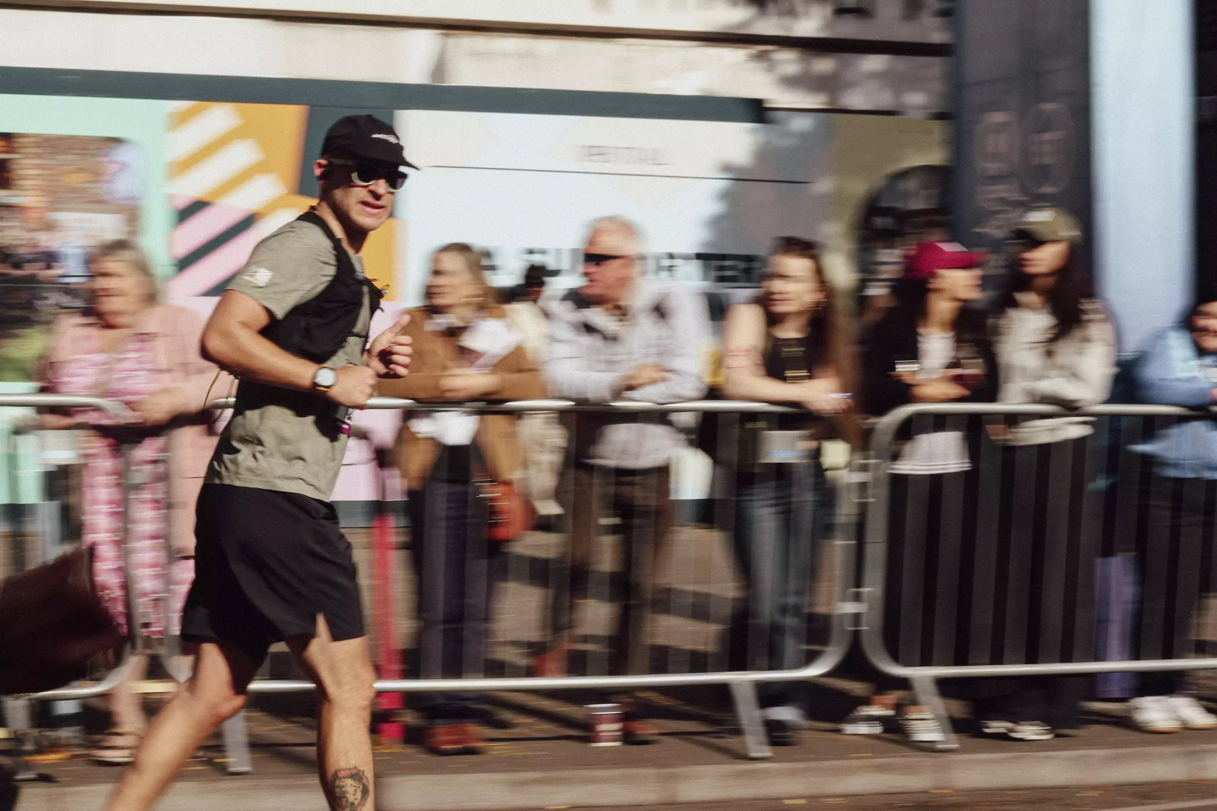 Man running past blurry supporters
