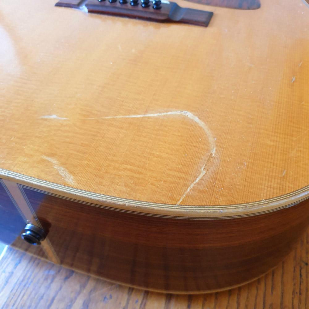 Scratch on acoustic guitar
