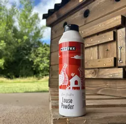 Nettex Louse Powder shaker pack next to poultry coop