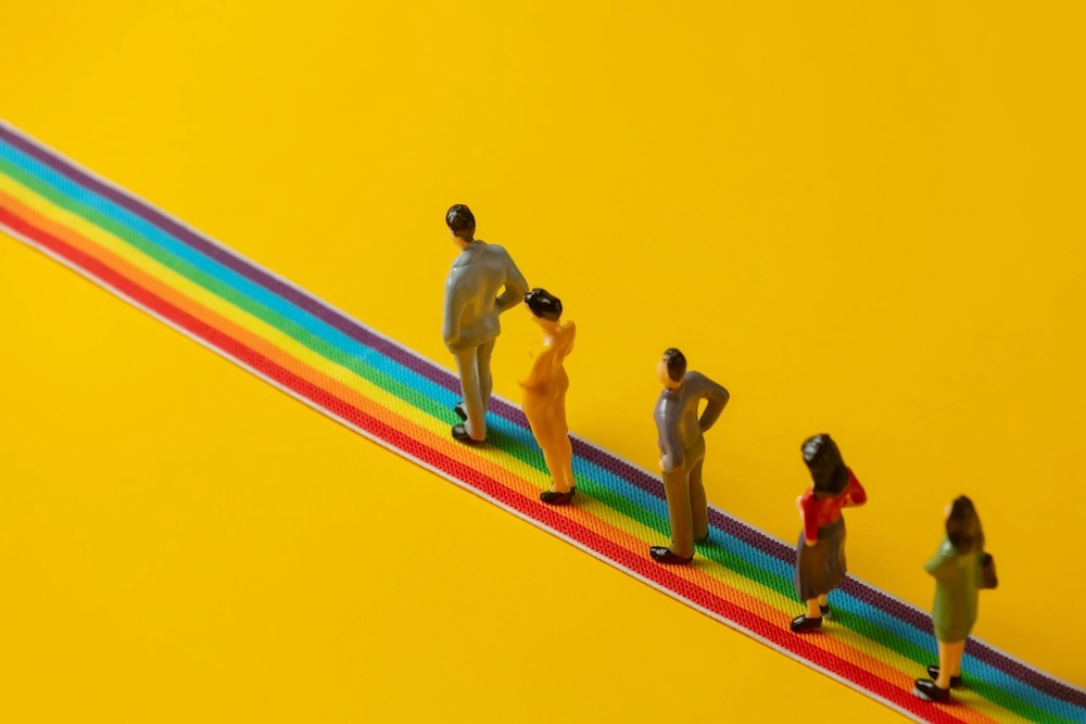 group-of-figures-of-people-stands-on-rainbow-strip-2023-11-27-05-29-22-utc.jpg