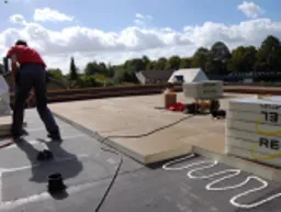 Recticel Powerdeck U flat roof insulation board Installation underway.webp