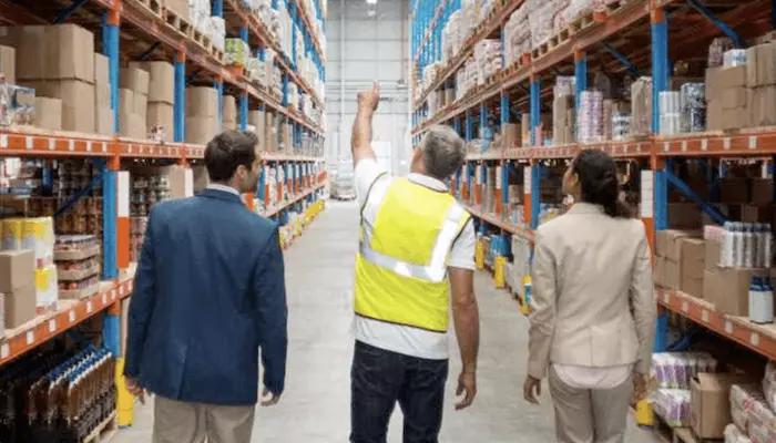 Feature Image of Warehouse Operative showing clients around Warehouse