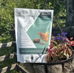 A Verm-X Poultry Zest packet next to flowers