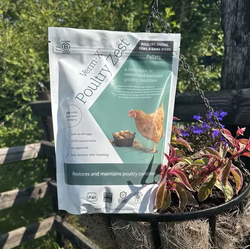 A Verm-X Poultry Zest packet next to flowers