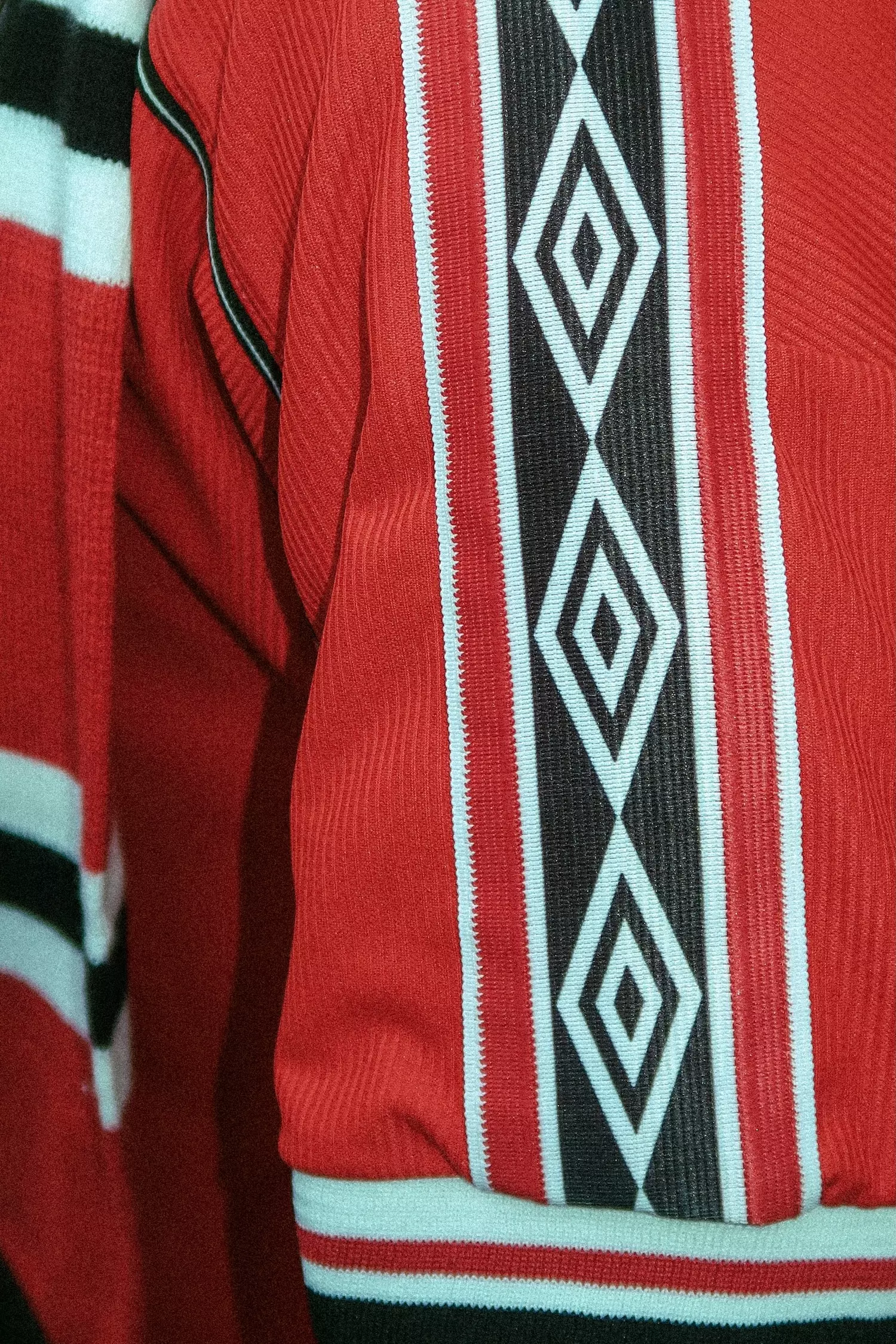 Close up of pattern work on the arm of a vintage Umbro Manchester United shirt