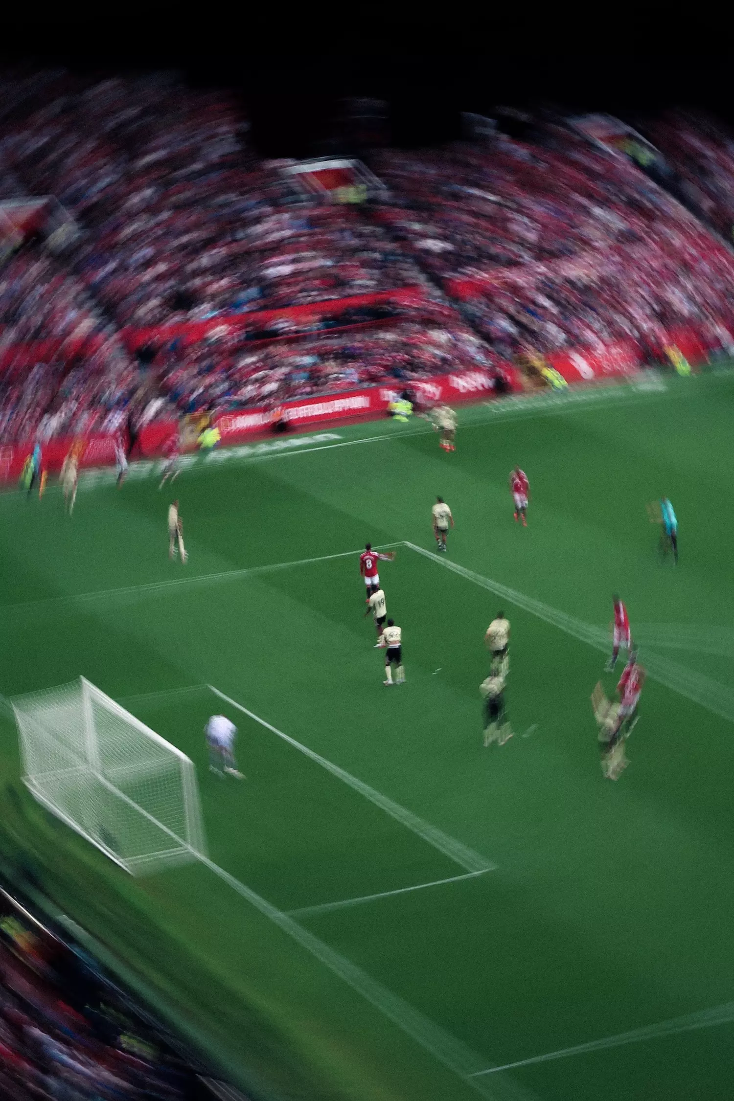 Motion blue top view inside Old Trafford football stadium watching Manchester United footballers playing against Ipswich Town