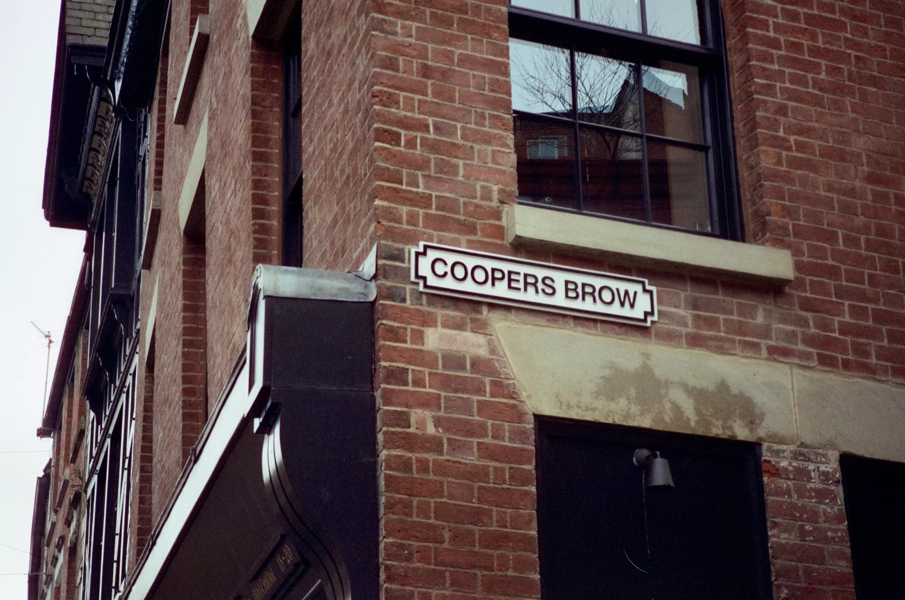 Brick Wall in Stockport with street sign