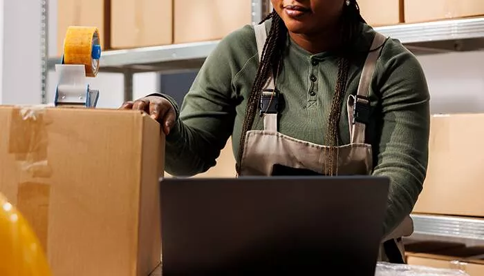 warehouse operative packaging up an order