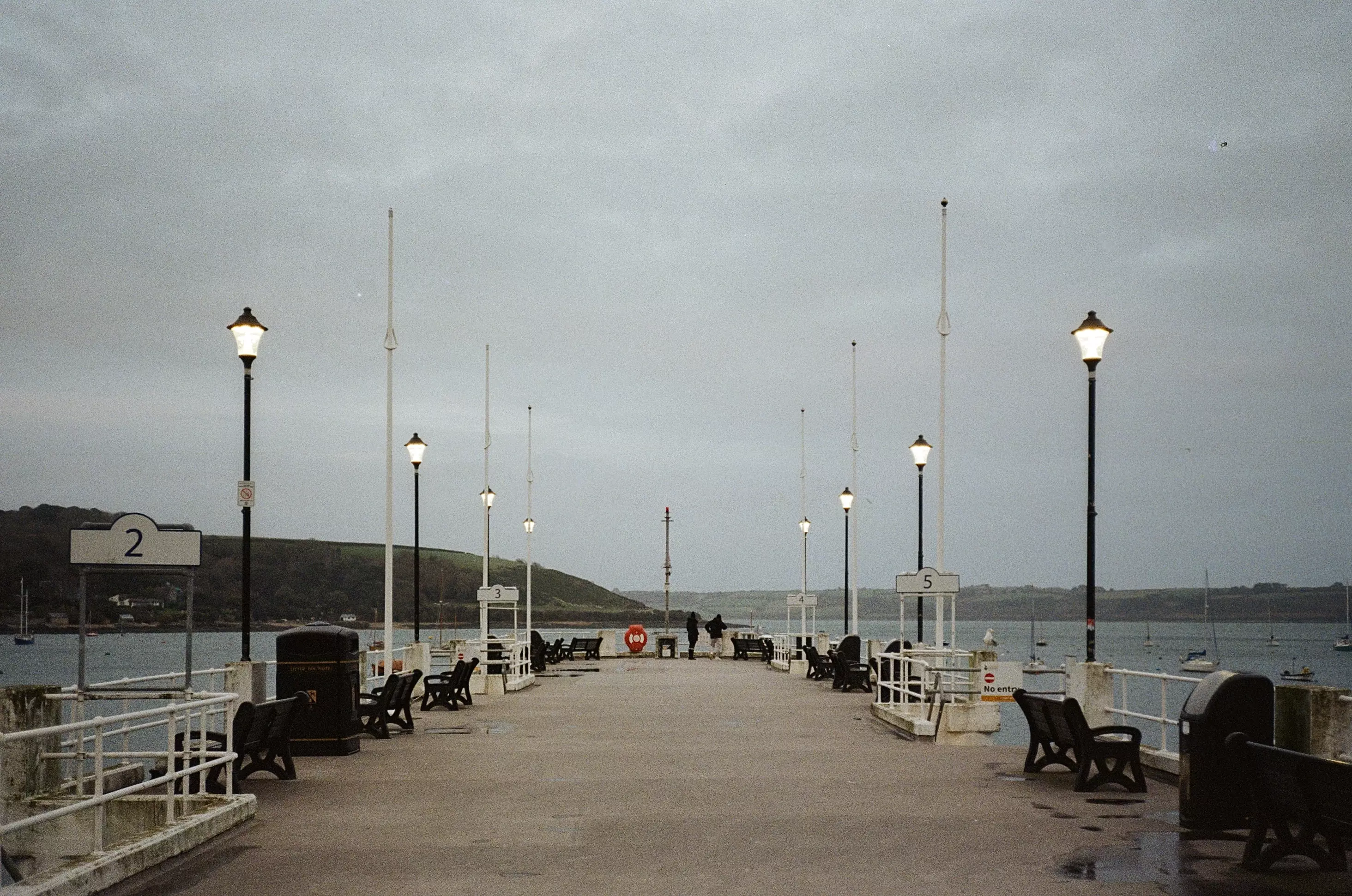 Wide shot of Prince of Wales Pier in Falmouth on a cloudy moody day
