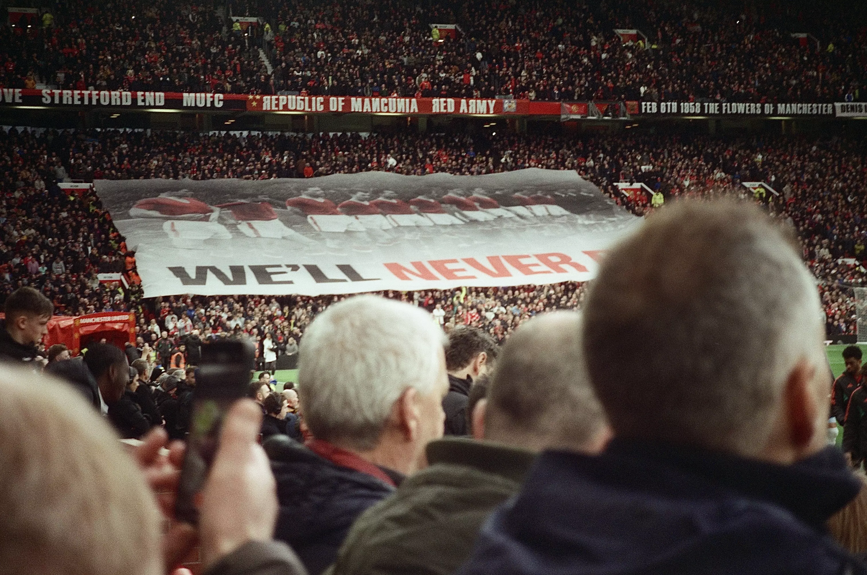 Large banner trailing across the crowd inside Old Trafford