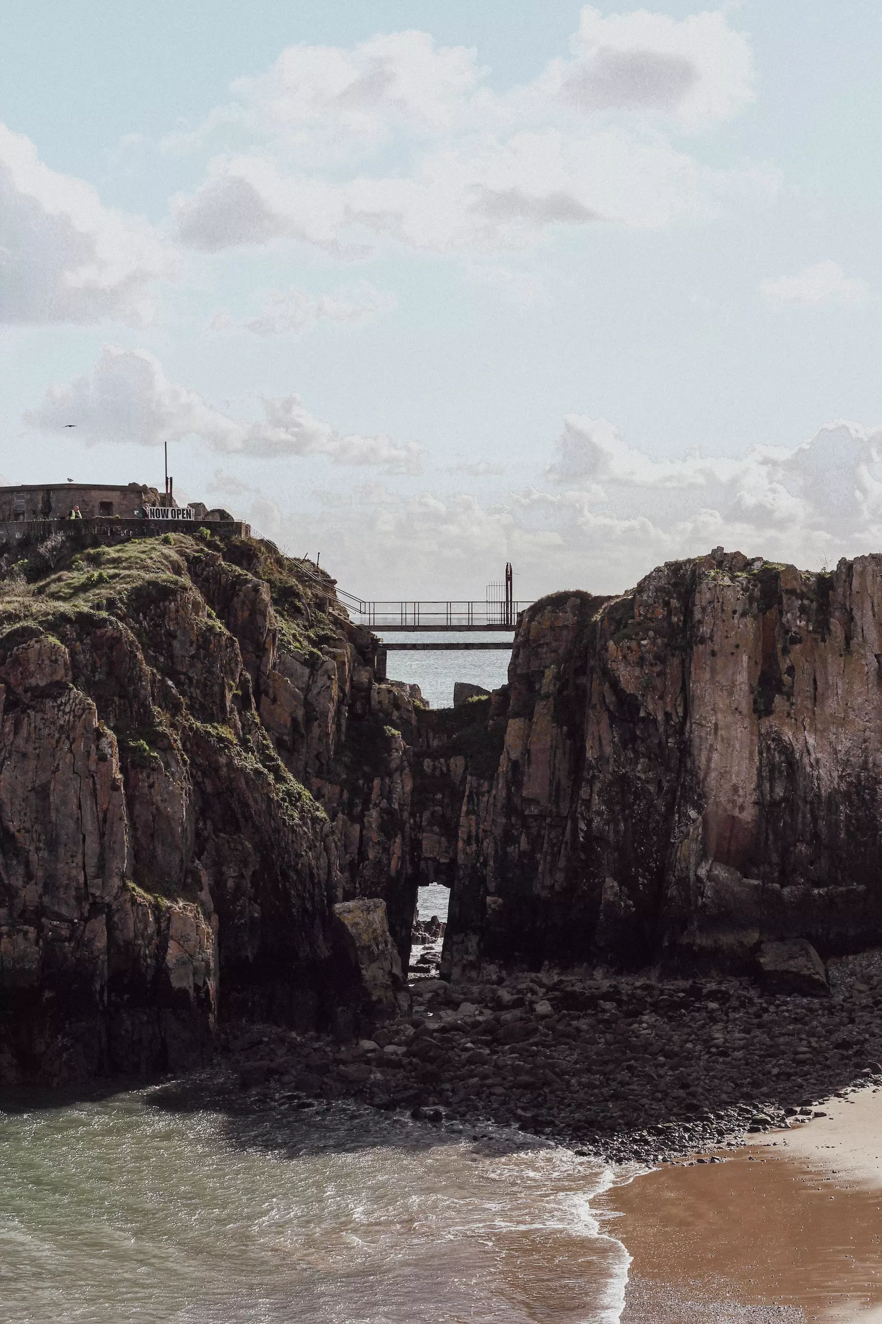 Bridge connecting two rocks at Tenby beach