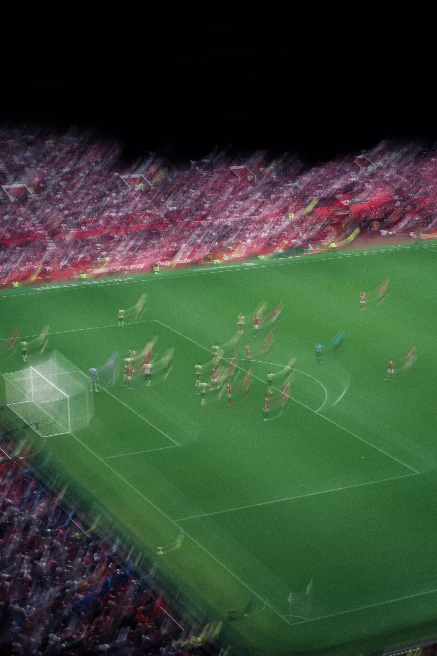 Blurry photo of inside Old Trafford football stadium watching Manchester United footballers playing against Ipswich Town