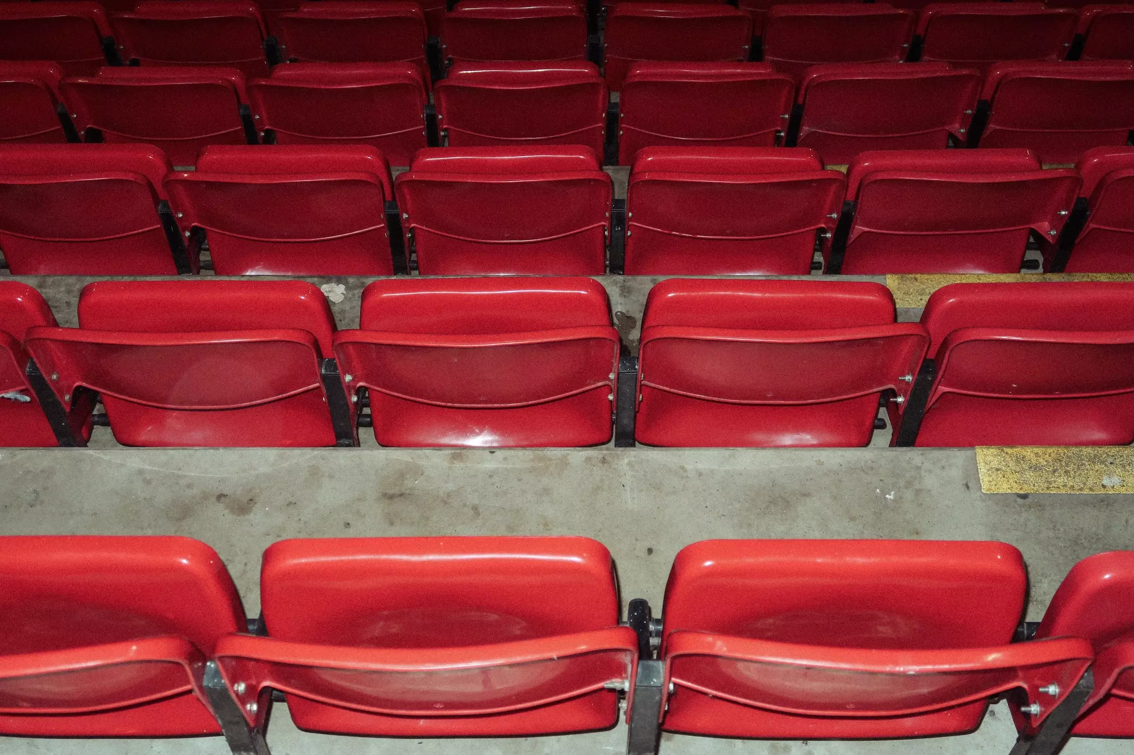Row of red seats inside Old Trafford football stadium