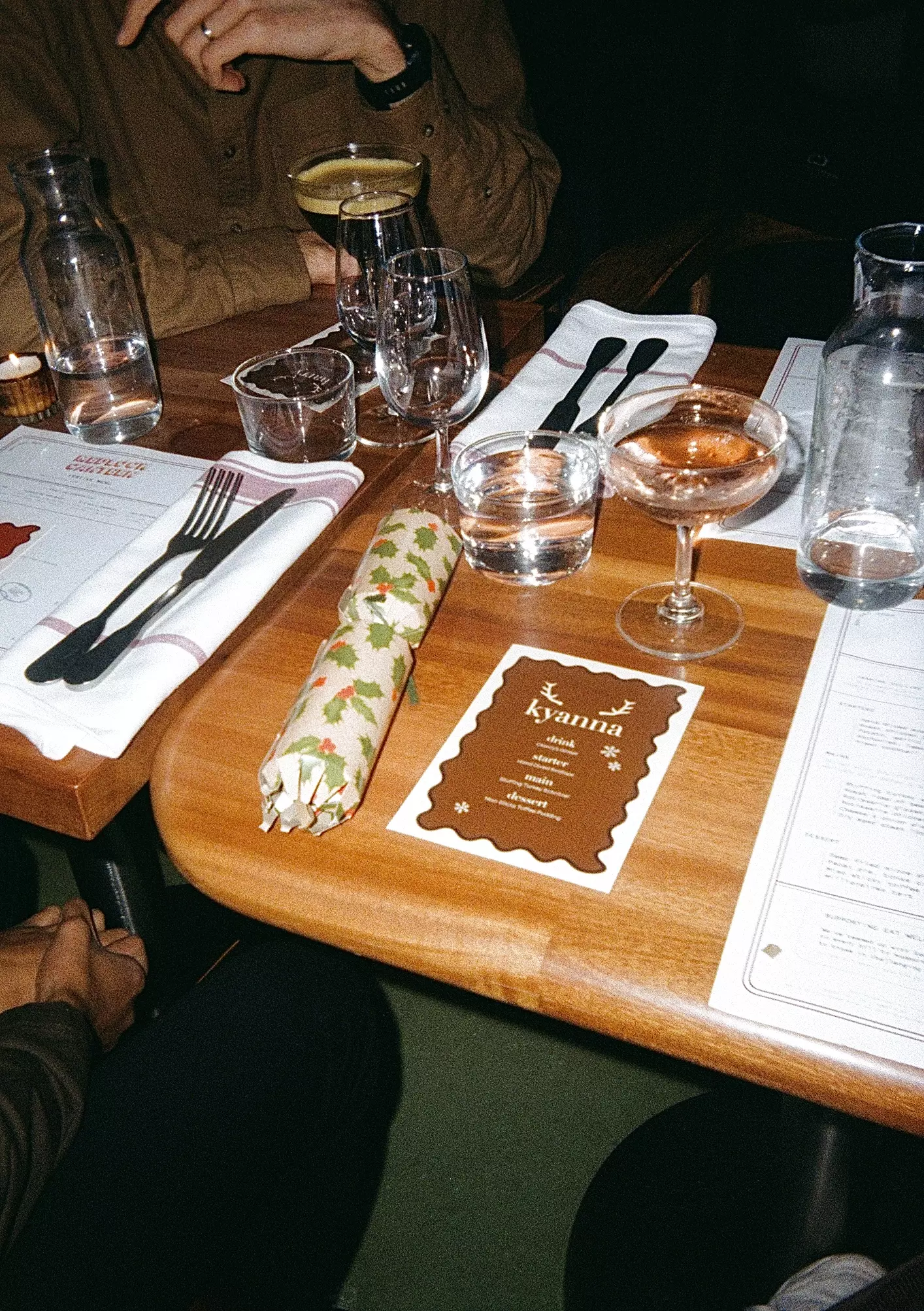 Flash photo of a table setting at a restaurant with drinks and table menus