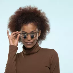 2023-03-ess-metro-brown-woman-blue-bg-0182-low crop.jpg