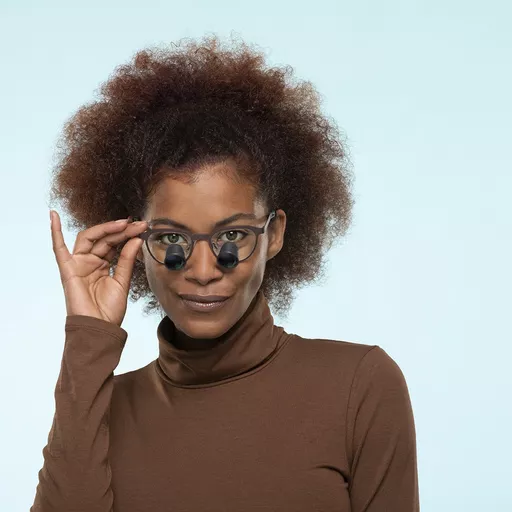 2023-03-ess-metro-brown-woman-blue-bg-0182-low crop.jpg