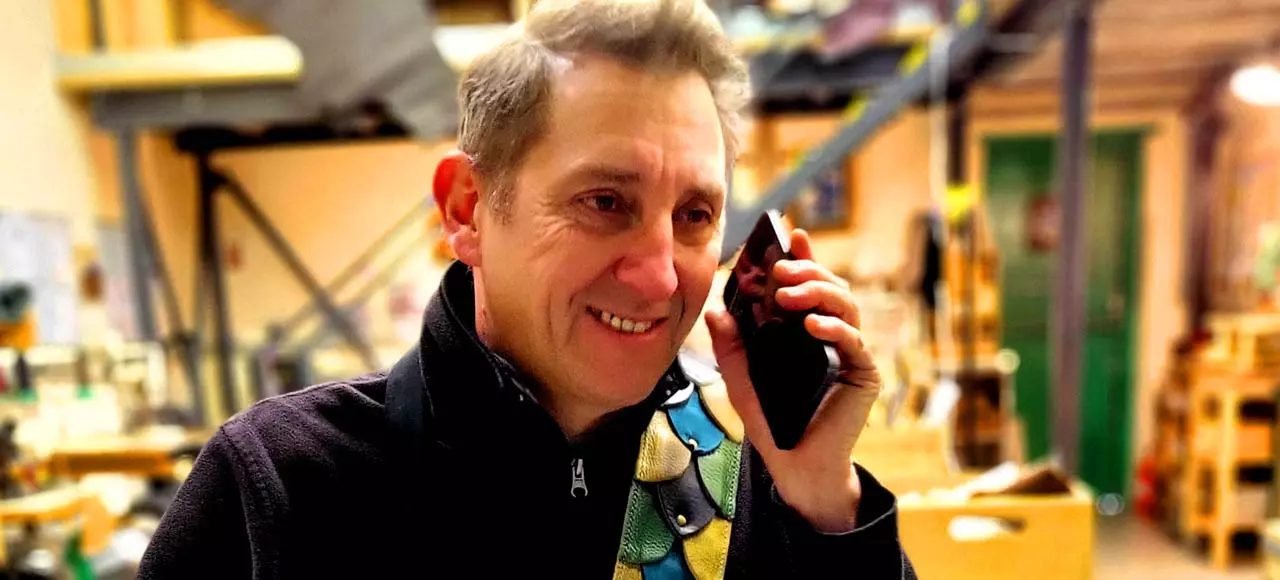 Rod on phone with guitar in workshop Jan 2025 1 edited.jpg