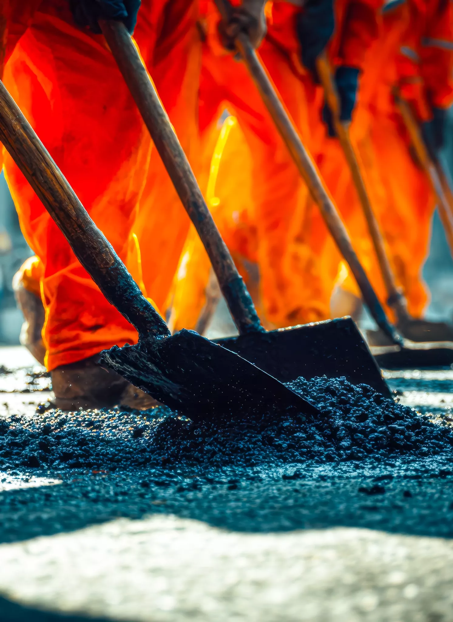 Construction-workers-in-orange-work-clothes-standing-on-a_70852049 CROPPED.jpg
